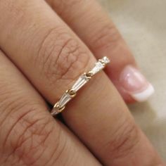 a woman's hand with a diamond ring on it