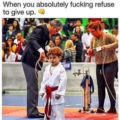 an image of a little boy getting ready to compete in a karate competition with his father