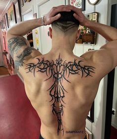 a man with a tattoo on his back