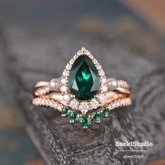 "Emerald Engagement Ring Set Rose Gold Pear Shaped Lab Emerald Bridal Set Halo Infinity Diamond Wedding Set Jewelry 2 Ring Set May Birthstone ITEM INFORMATION Metal Type - Solid 14k Rose Gold Band Width - (approx. 2.2mm) Engagement ring: Center Stone - 6x9mm Lab emerald, Pear Shaped Side Stone - Akoya Pearl & Lab Emerald Size- 2.5-1.6mm Side Stone - Natural Diamond, H color, SI clarity/Moissanite, D color, VVS clarity Weight - 0.57ct **Stone Replacement** Available with any other gemstones, Green Cubic Zirconia Bridal Set For Anniversary, Teardrop Gemstone Wedding Jewelry, Wedding Jewelry With May Birthstone Teardrop Shape, Wedding Teardrop Ring With May Birthstone, Teardrop May Birthstone Ring For Wedding, Teardrop May Birthstone Wedding Ring, Teardrop May Birthstone Jewelry For Wedding, Green Engagement Rings, Emerald Engagement Ring Green