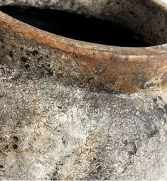 a close up of an old pot with dirt on it's sides and holes in the surface