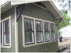 a green house with white trim and windows