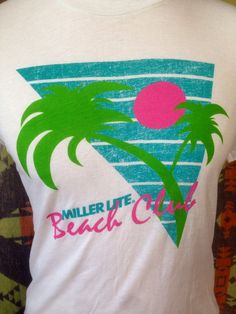 a white t - shirt with palm trees and the words miller lite beach club on it