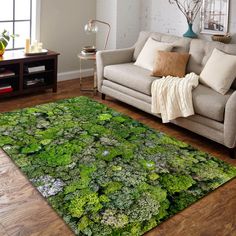 a living room with a couch, chair and rug covered in green mossy plants