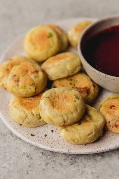 small biscuits on a plate with dipping sauce