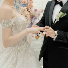 the bride and groom are getting ready for their wedding ceremony at the water's edge