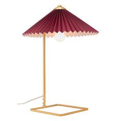 a red and gold lamp on a white background