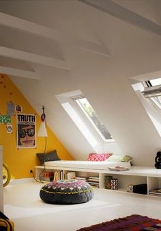 an attic bedroom with bright yellow walls and white carpeted flooring, built in bookshelves