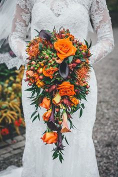 a bride holding a bouquet of flowers in her hands