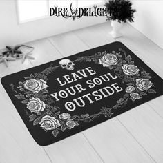 a black mat with white roses on it and the words leave your soul outside printed on it