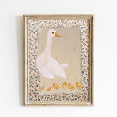 a painting of a duck and her chicks is hanging on the wall in an old frame