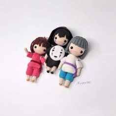 three small dolls are sitting next to each other