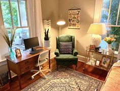 a living room filled with furniture and a laptop computer sitting on top of a desk