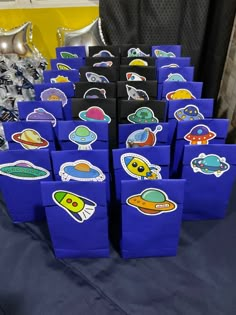 there are many bags that have space stickers on them, all in different shapes and sizes