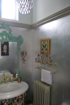 a bathroom with a sink, mirror and radiator