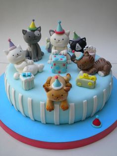 a birthday cake decorated with cats and kittens