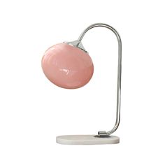 a pink table lamp on a white base with a metal arm and round light fixture