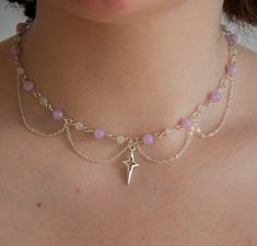 This celestial-inspired piece is a must-have for those looking to add a touch of elegance to your jewellery collection. The centrepiece of this stunning necklace is a radiant silver sun/star pendant adorned with pastel purple and white beads. It also showcases a handcrafted arrangement of delicate chain layers, each contributing to its intricate and delicate aesthetic. Whether you're attending a special event, enjoying a romantic evening, or simply adding a touch of celestial elegance to your everyday style, this necklace will be your go-to accessory. With its timeless beauty and versatility, this necklace makes a perfect gift for yourself or a loved one. The delicate silver chains gracefully cascade, creating a subtle and ethereal look that complements both casual and formal attire. Versa Necklace With Stones Gemstones, Teardrop Bead Jewelry, Diy Jewelry Ideas Aesthetic, Chain And Bead Necklace, Purple Necklace Beads, Beaded Necklace Inspiration, Coquette Jewelry Aesthetic, Delicate Aesthetic, Beading Necklace