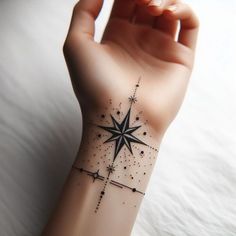 a person's arm with a tattoo on it and a star in the middle