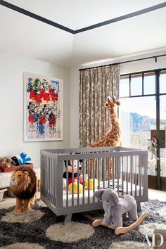 a baby's room with stuffed animals and toys on the floor, including a crib