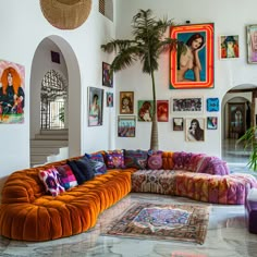 a living room filled with furniture and pictures on the wall