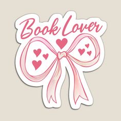 a sticker with the words book lover and hearts in pink ink on a white background