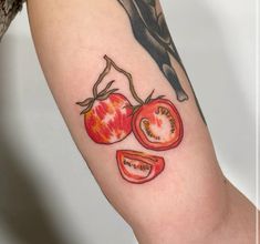 a tattoo with tomatoes on the arm