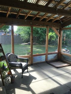 a covered patio with a bench and chair