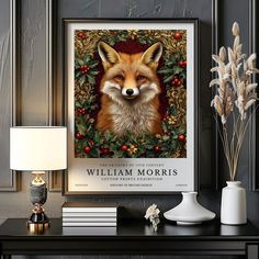 a painting of a fox with holly wreaths on it's head is displayed next to a lamp