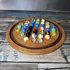 a wooden board with marbles on it