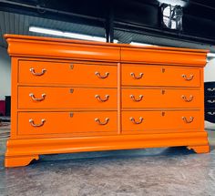 an orange dresser is sitting in a garage