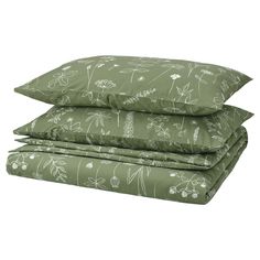 three pillows stacked on top of each other with green and white floral designs in them