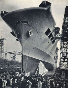 an old black and white photo of people standing around a large ship that is being built