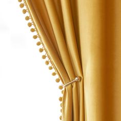 an open curtain with pom - poms on it