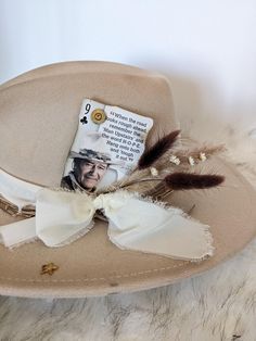 John Wayne "The Duke" Cowboy Playing card to add to your hat band for a custom hat. Accented with a 9mm Luger casing or  Winchester 45 !  Want to customize your favorite hat? Add a Hat band, Pin and Cowboy playing card for a custom look.  Add the boho dried flower cluster to this order, so easy just stick it in your hat band.  Update your favorite western hat.  The possibilities for a custom hat are endless!  Plenty of card options-- message me for more options!!   Looking for a different card let me know - I have a ton of them!!  These cards come with burnt corners and can be cut down to fit nicely in your hat band. Want help designing the perfect hat accessories?  Message me I would love to help build you a custom listing!    This order is for one cowboy playing card or one feather clust Creative Hats, Flower Cluster, Western Hats, John Wayne, Cow Boy, Stick Pins, Playing Card