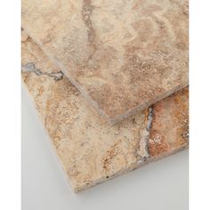 two pieces of marble with different colors and patterns on the top one is brown, tan, and white