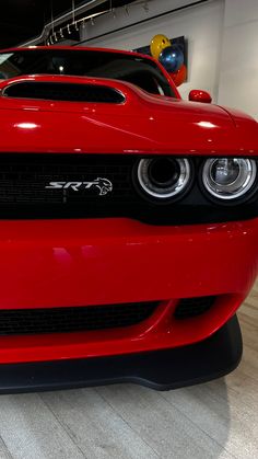 the front end of a red sports car