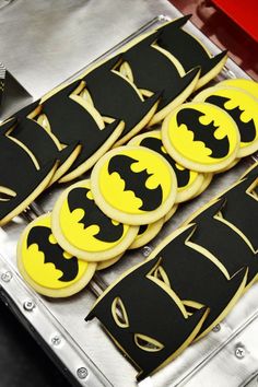 decorated cookies are sitting on top of a cookie sheet in the shape of batmans