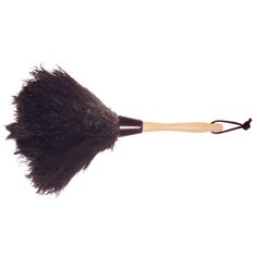 a close up of a brush on a white background with a black handle and wooden tips