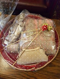 a red plate topped with lots of wrapped presents