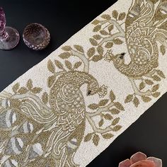 the table is covered with an intricately designed cloth