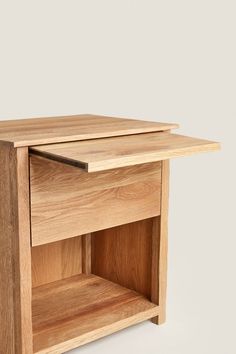 a small wooden table with one drawer open