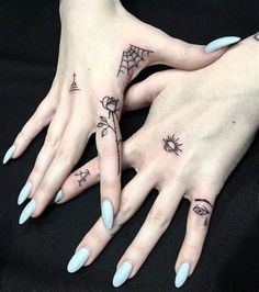 two women's hands with tattoos on them