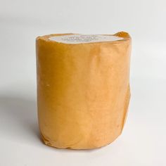 a piece of cheese sitting on top of a white table