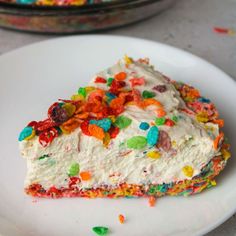 a piece of cake with white frosting and multicolored sprinkles