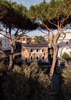 an old building surrounded by trees and buildings