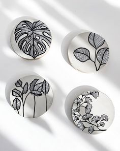 three plates with designs on them sitting next to each other in front of a white background