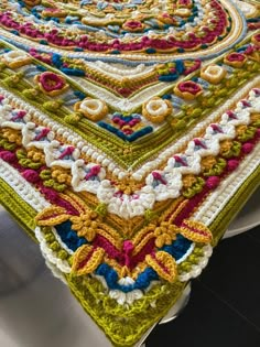 a crocheted tablecloth is displayed on a plate