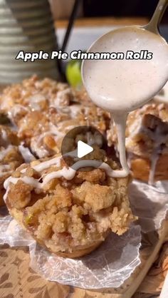 an apple pie cinnamon rolls being drizzled with icing