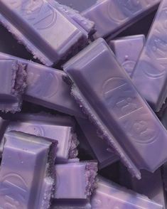 a pile of purple candy bars sitting on top of each other